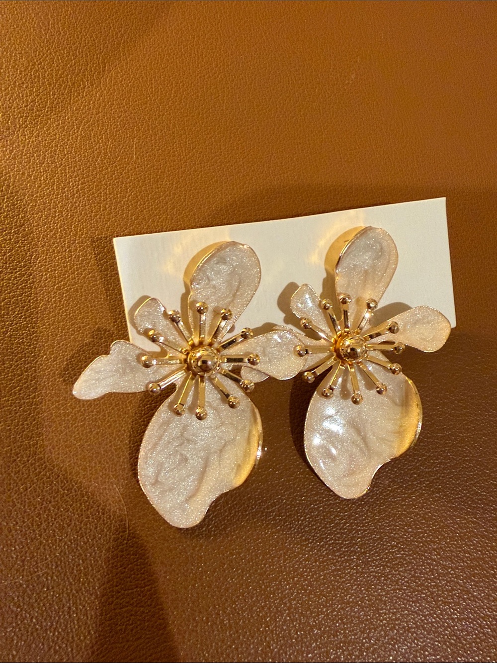 Emu Shimmery White Floral Drop Earrings with Gold Accents